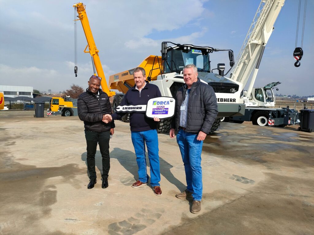 Tendayi Kudumba, GM: Earthmoving at Liebherr-Africa (far left), hands over the first TA 230 in Africa to Gordon Watson, MD of Orca (middle), with Ian Duncan, MD of DieselPro Services (Liebherr-Africa’s Zimbabwean dealer) looking on.  