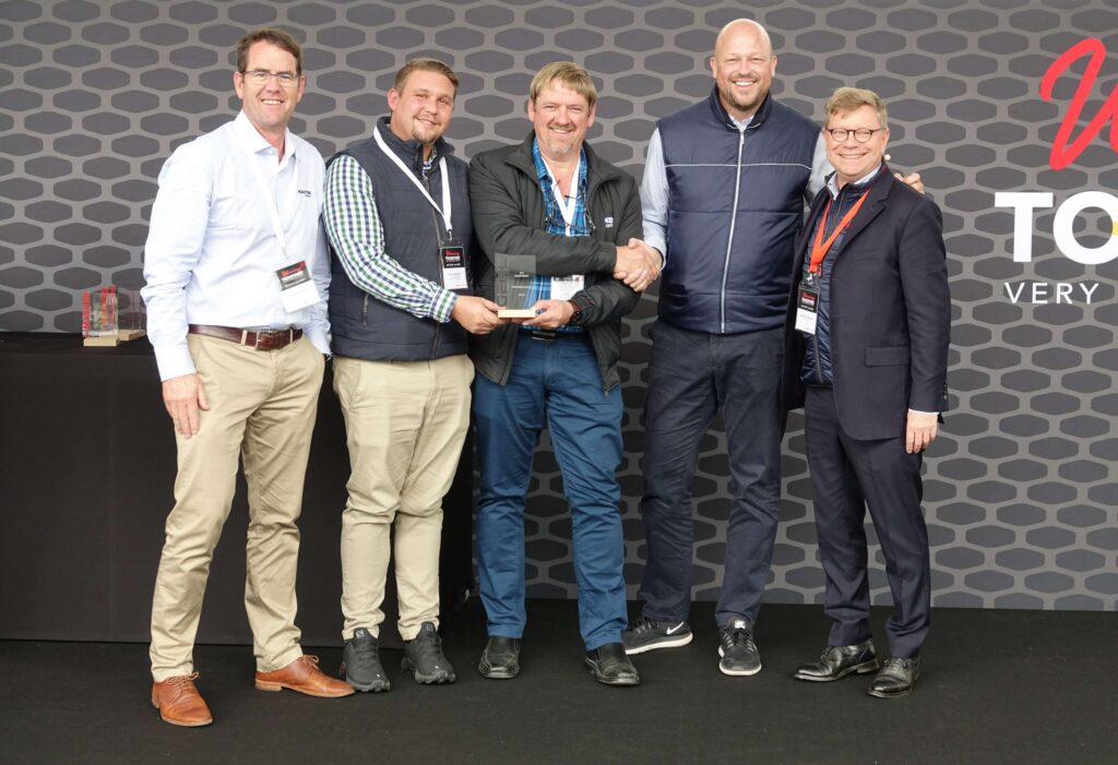ELB Equipment CEO, Desmond van Heerden (middle) receives the status of partner dealer at the recent GEHL conference in France.