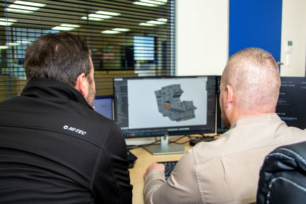 Design professionals employing specialised software to create a detailed model of a Weba transfer chute.