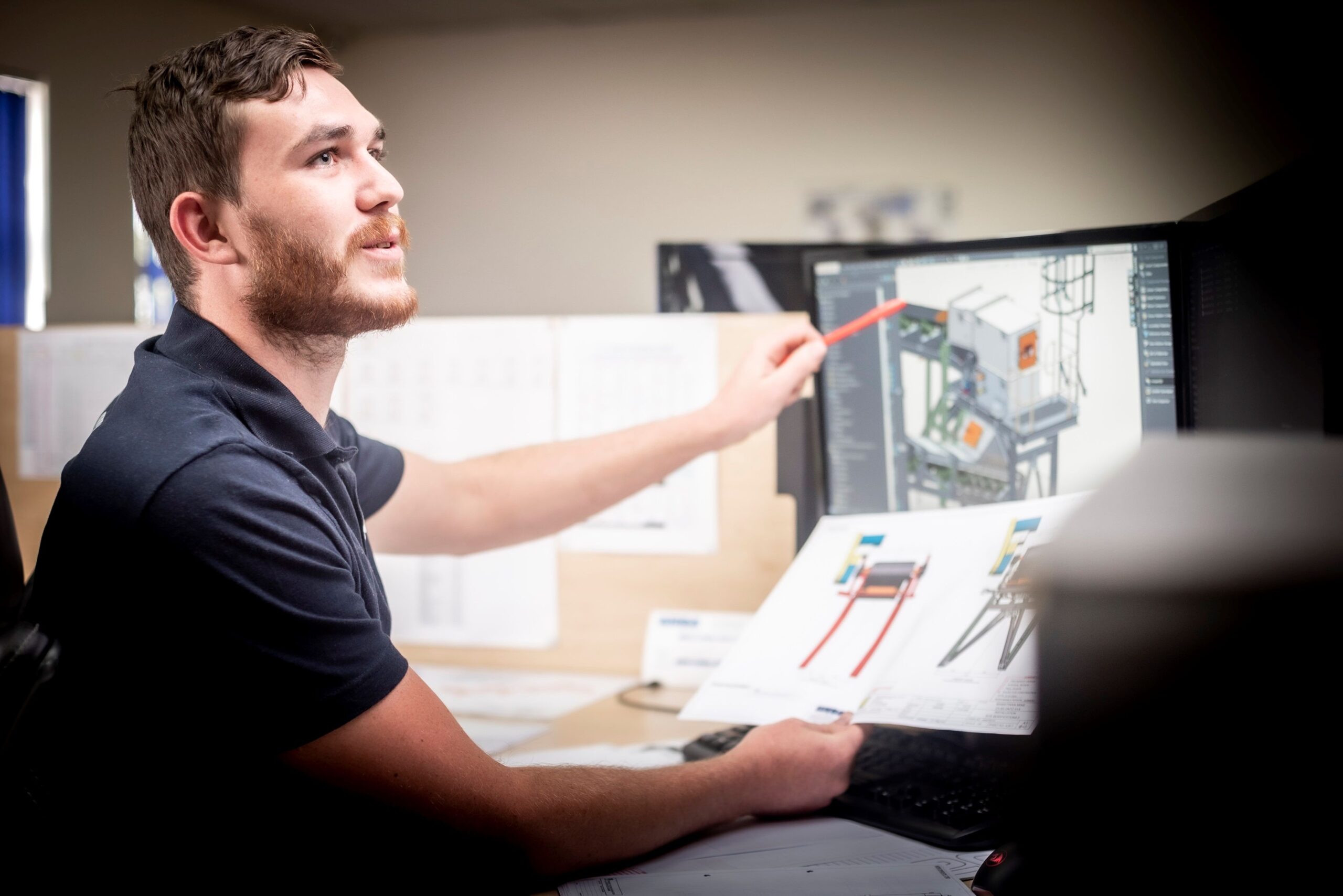 Experienced Weba Chute Systems draughtsman comparing drawings with the 3D model.