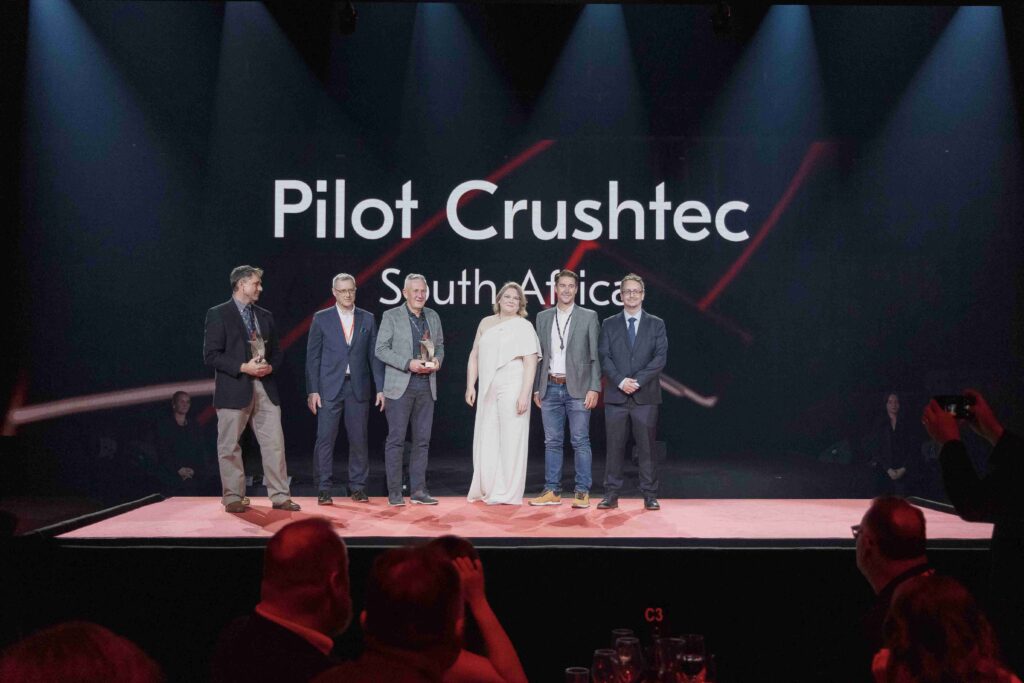 Sandro Scherf, CEO of Pilot Crushtec (third from left), and Francois Marais, Sales and Marketing Director of Pilot Crushtec (second from right), receiving the award for 2nd place Lokotrack Distributor Award.