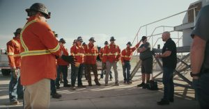 MSTs gather near a heavy-duty conveyor specifically set up for training purposes, ready to properly install new equipment.