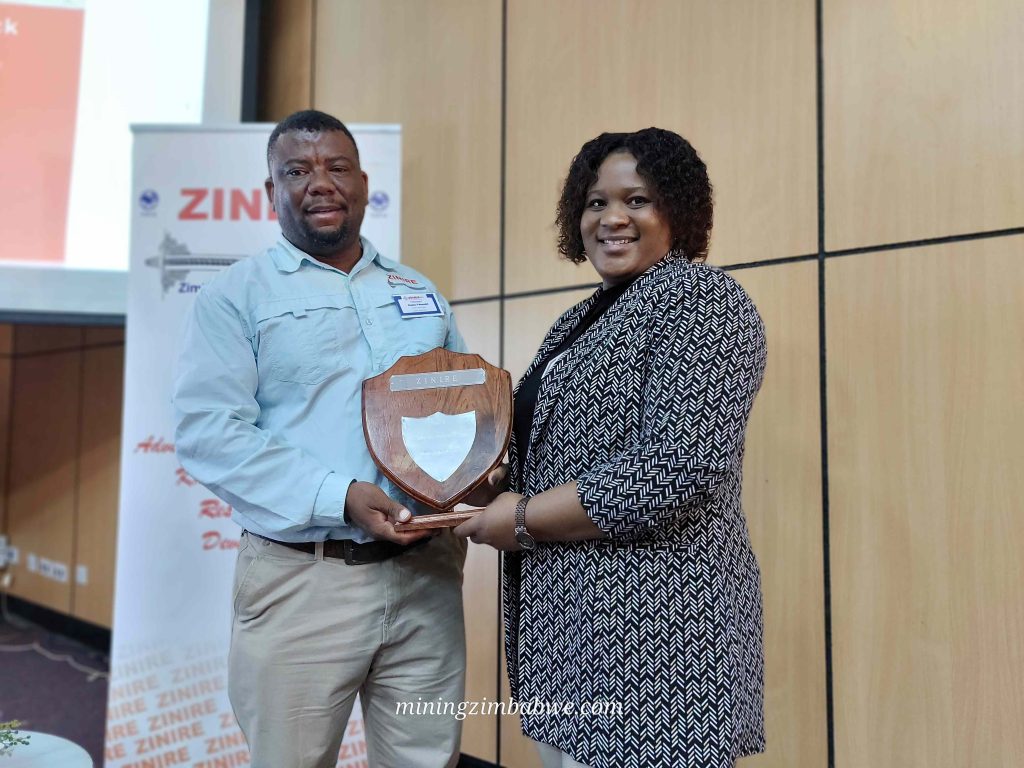 SRK Consulting mining geotechnical engineer Fungai Kwangwari (right) recently earned the Best Technical Presentation award at the Zimbabwe National Institute of Rock Engineering symposium in Bulawayo.