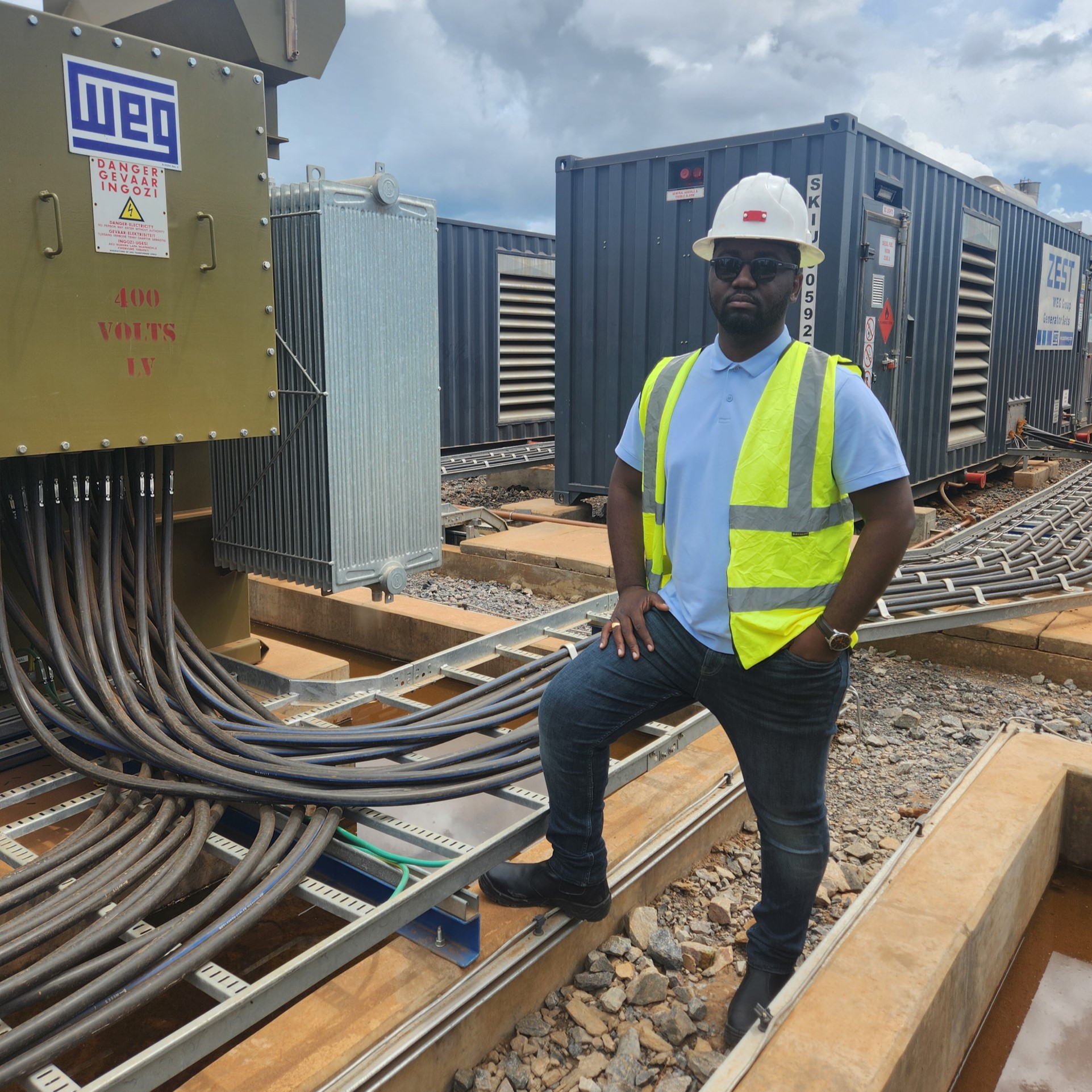 Thierry Kakese, WEG’s regional manager – Central Africa, in front of WEG transformers on a mine in the DRC.