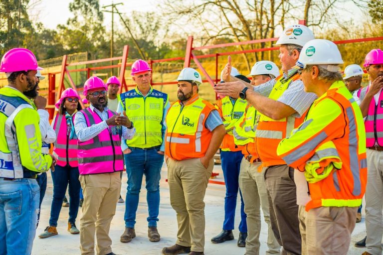 SANRAL CEO Reginald Demana (in pink vest) receiving a briefing from main contractors in the Key Ridge to Hammarsdale project.