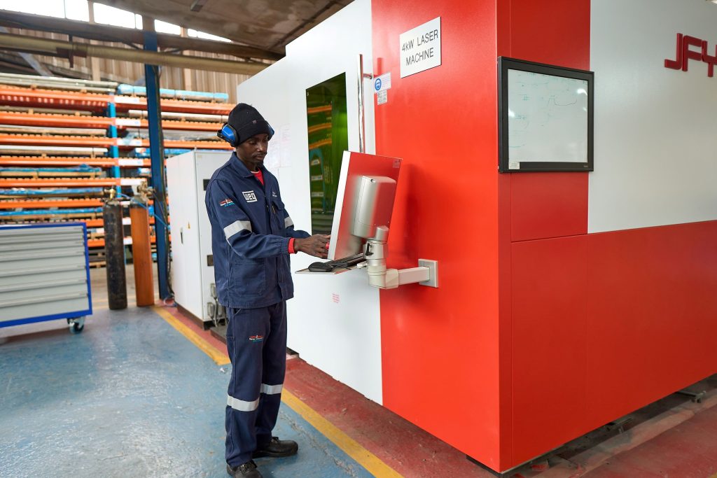 WEG machine operator inputting data into the new laser machine.