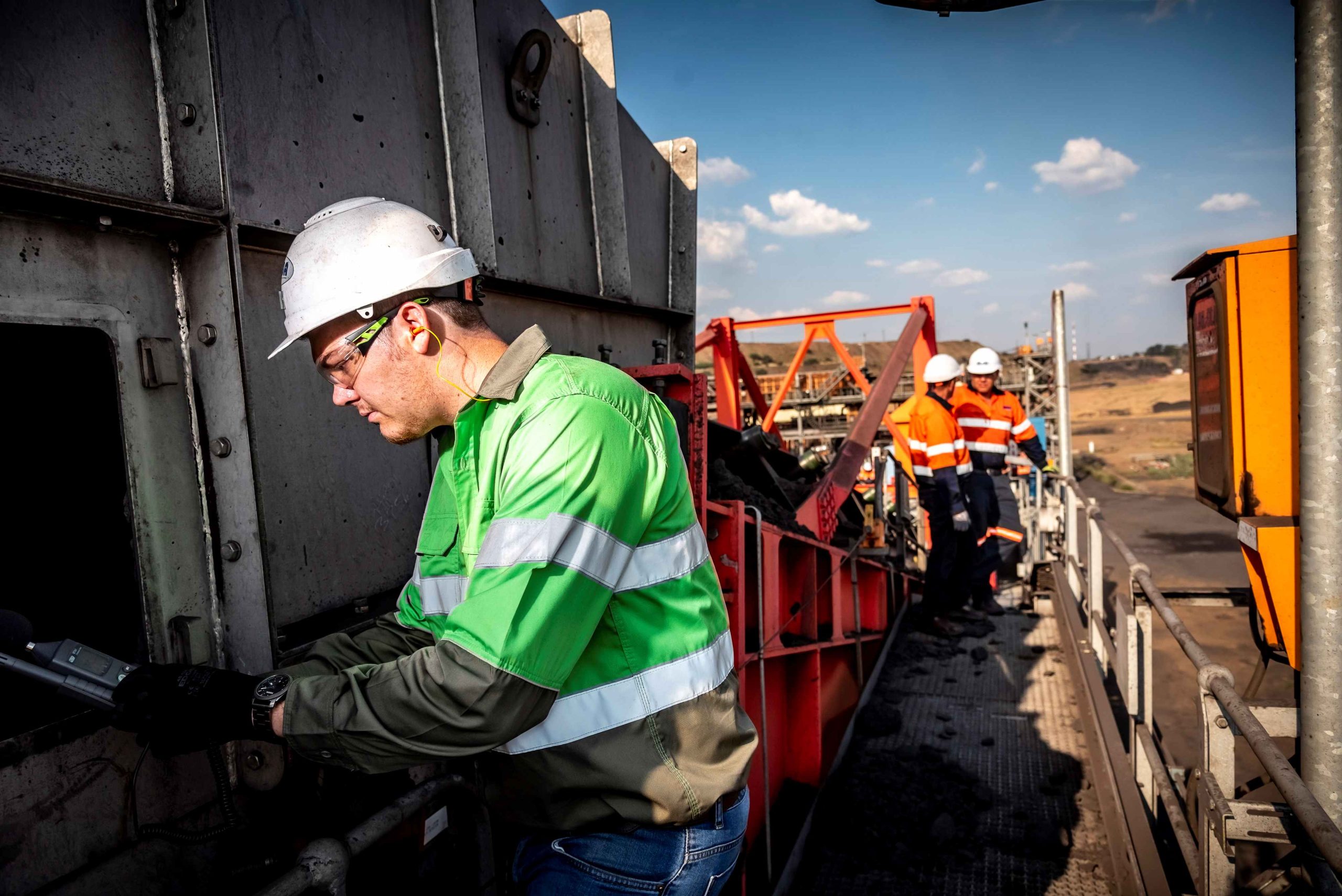 A Weba Chute Systems manager conducting dust tests at a Weba chute, ensuring that the design’s dust control measures are working effectively in the field.