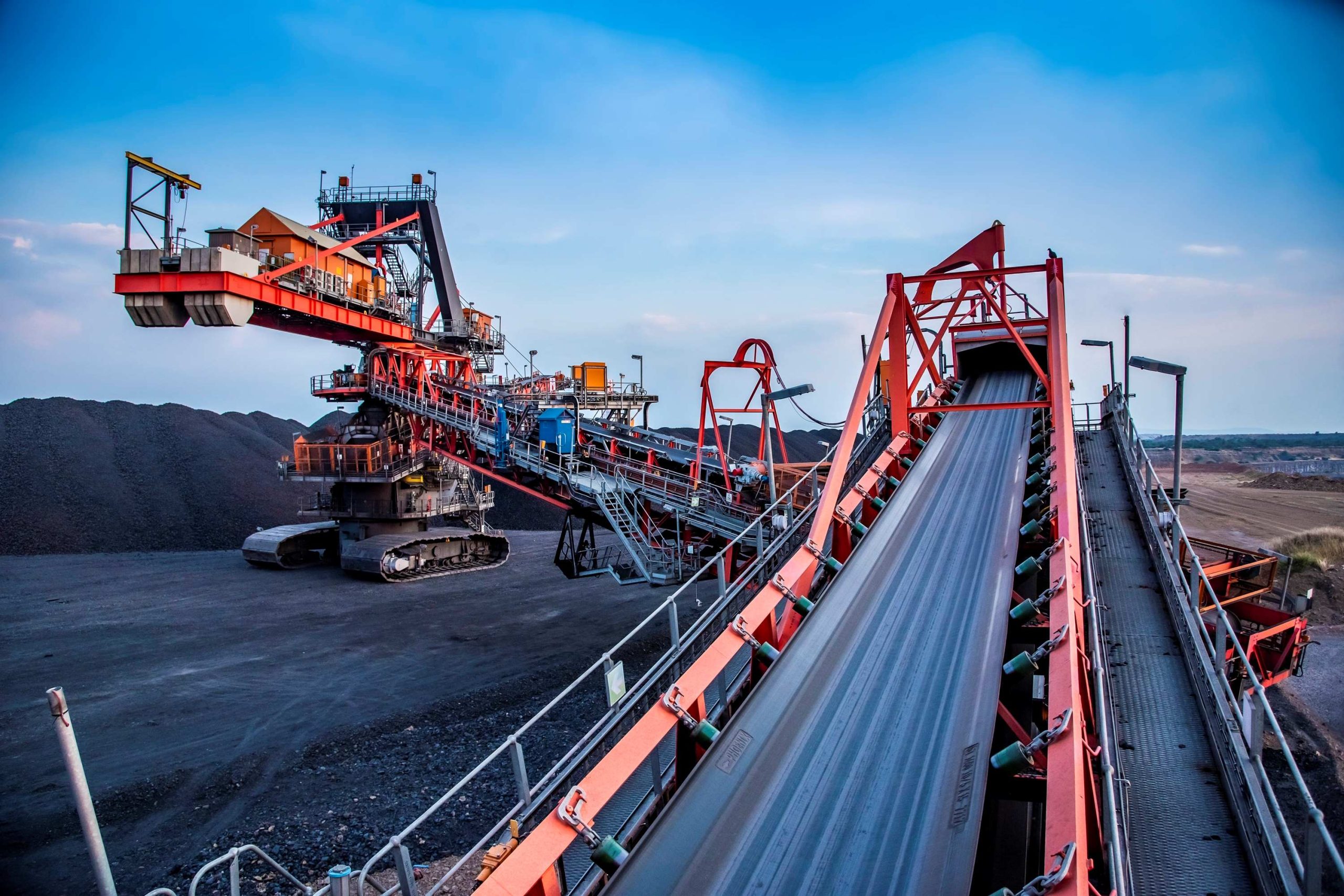 Conveyor belts channel ore smoothly into a custom-designed Weba Chute ensuring controlled flow and minimal wear in abrasive conditions typical of Southern Africa's mining operations.