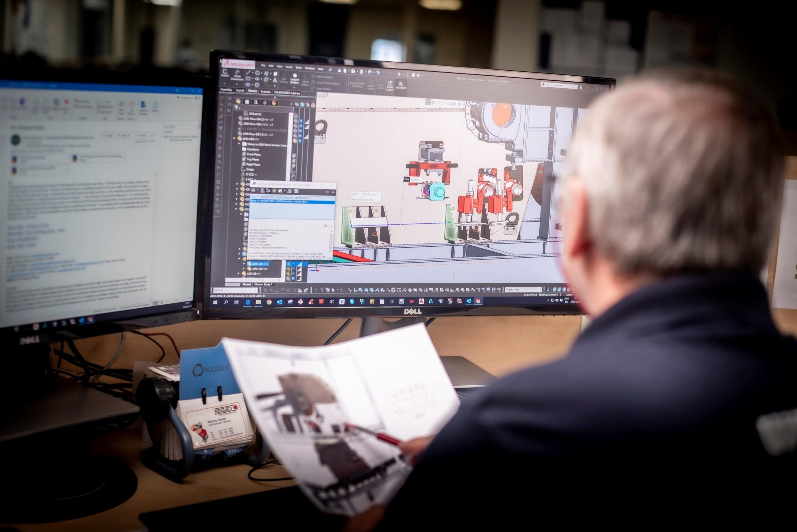 At Weba Chute Systems, a draughtsman reviews a design on CAD, ensuring precision and accuracy in custom-engineered transfer solutions.