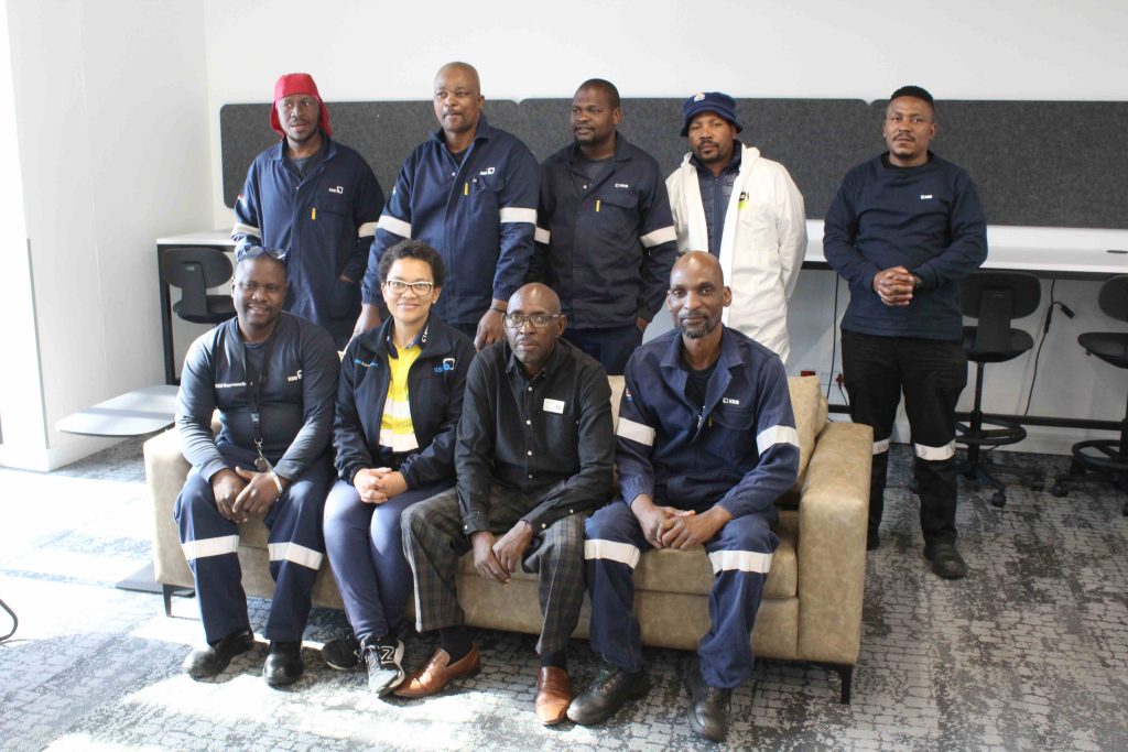 Nicola Ntshavheni, KSB’s Skills Development Facilitator, and Ashbey Moyo, a longstanding Triple E Training Facilitator, as well as the five KSB Group employees who will complete their final adult education and training in literacy and numeracy.