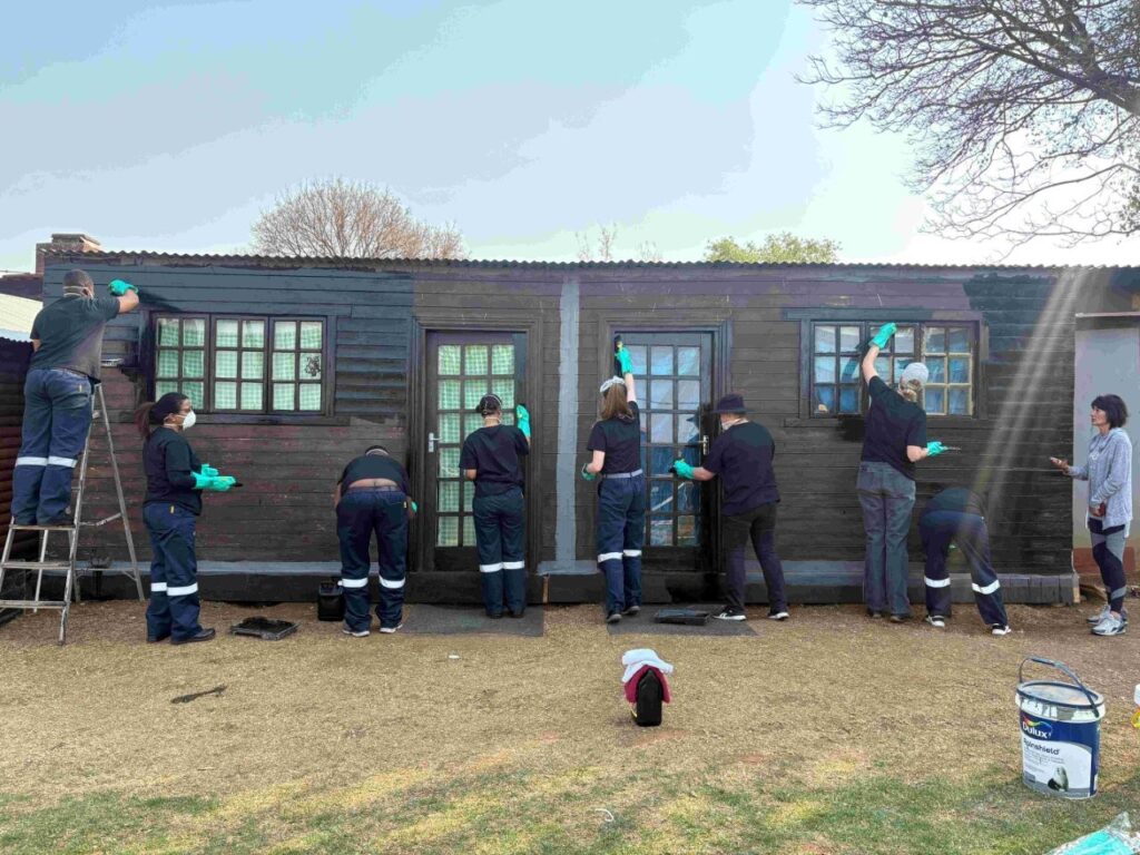 The team painted and refurbished two newly built wooden homes.
