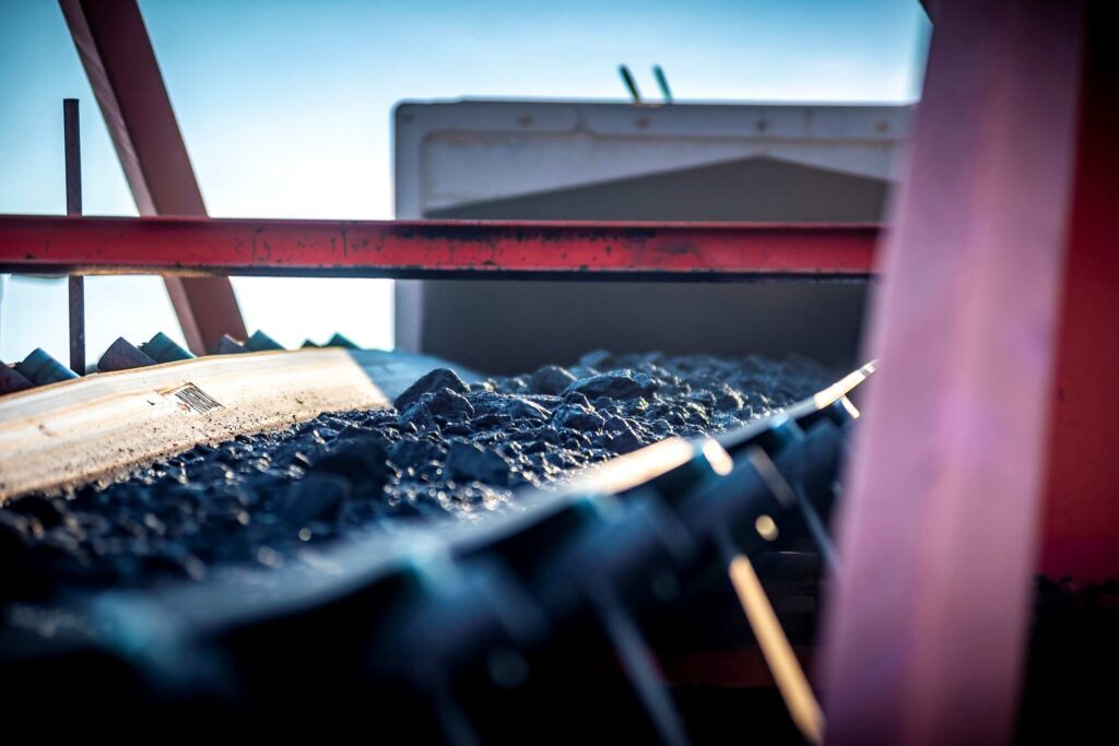 A Weba Chute Systems head chute directs the coal stream along a controlled trajectory, supporting consistent belt alignment and reliable material handling.