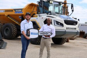 Alex Wirtz, technical service and sales manager at Windhoek Renovations Plant Hire and Tendayi Kudumba, earthmoving general manager at Liebherr-Africa during the handover of the TA 230.