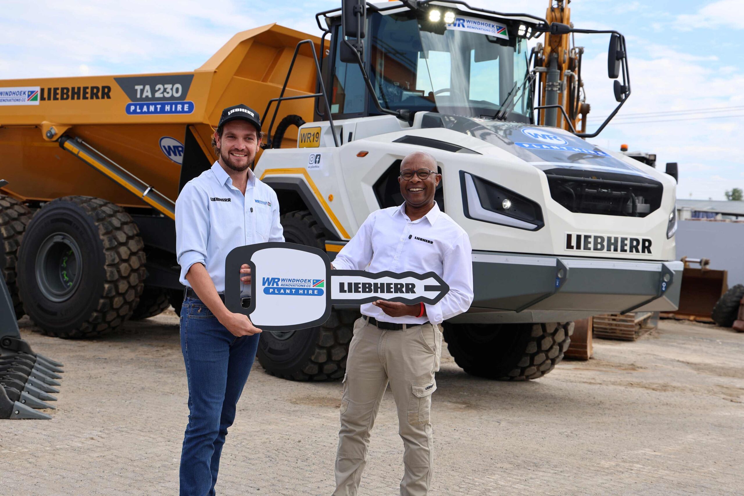 Alex Wirtz, technical service and sales manager at Windhoek Renovations Plant Hire and Tendayi Kudumba, earthmoving general manager at Liebherr-Africa during the handover of the TA 230.