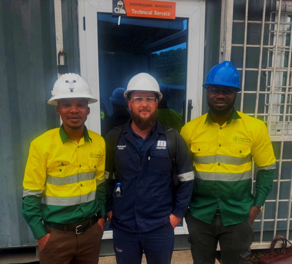 Aggrey and Martin representatives work together on a project at a mining site in Ghana.