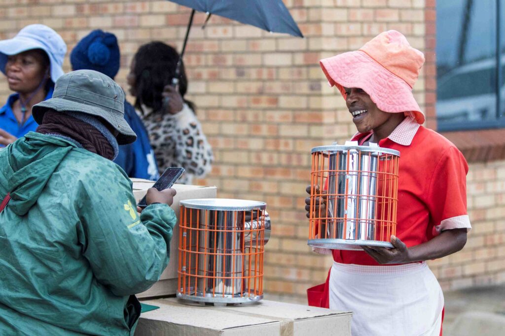 Cooking with an energy-efficient cookstove that uses less fuel and produces fewer emissions.